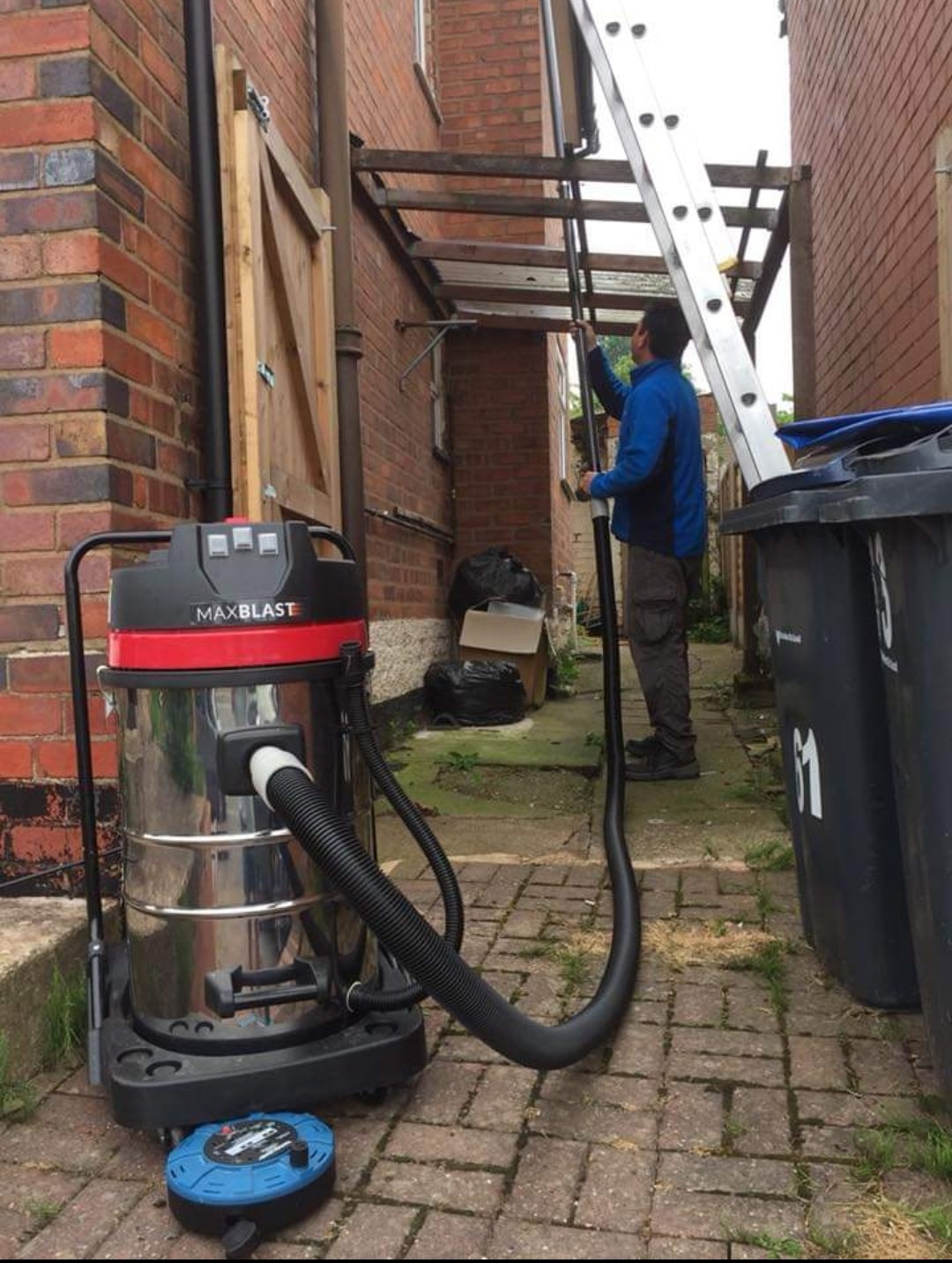Vacuuming gutters in an awkward spot.